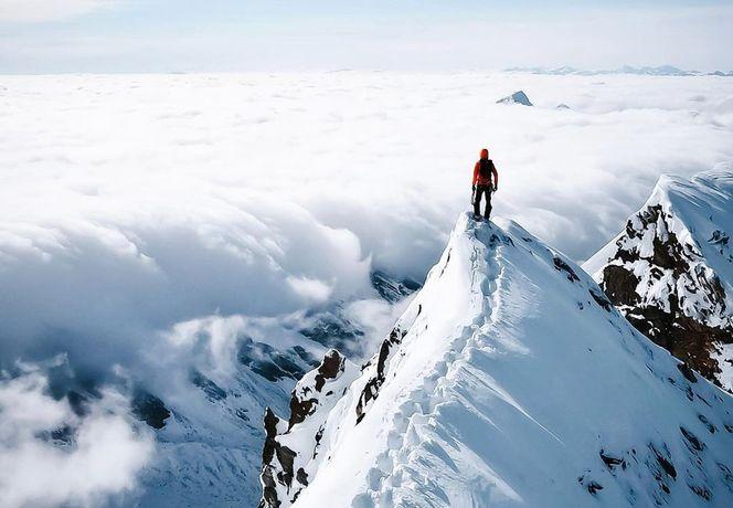 Man standing on mountain summit